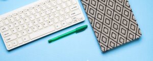 Keyboard, notebook and pen. Writing concept